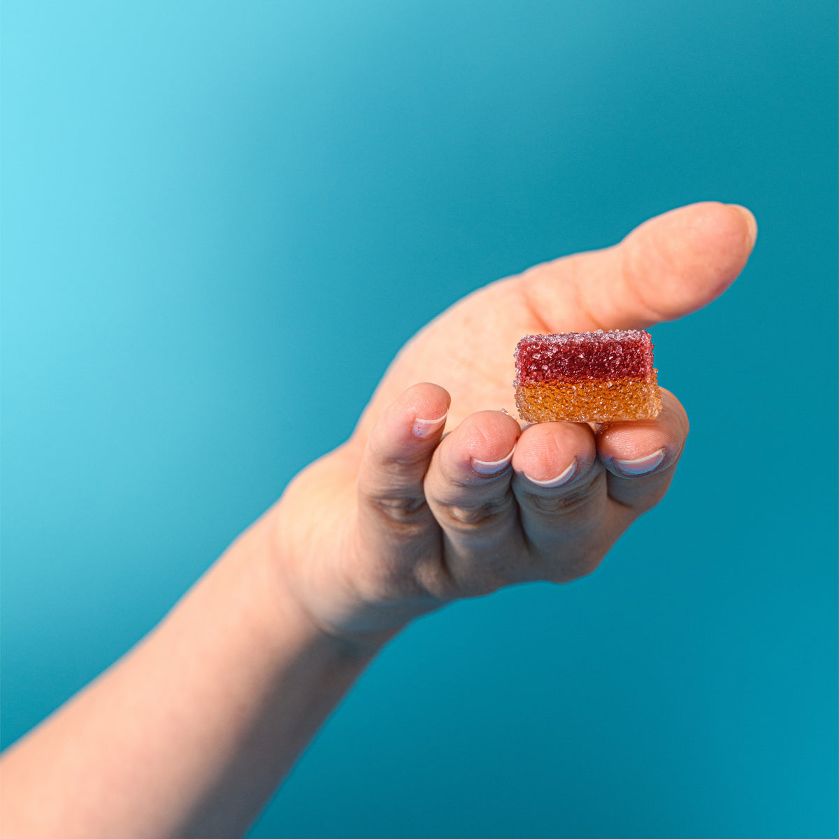 Caramella gelée fragola e kalamansi tenuta in mano