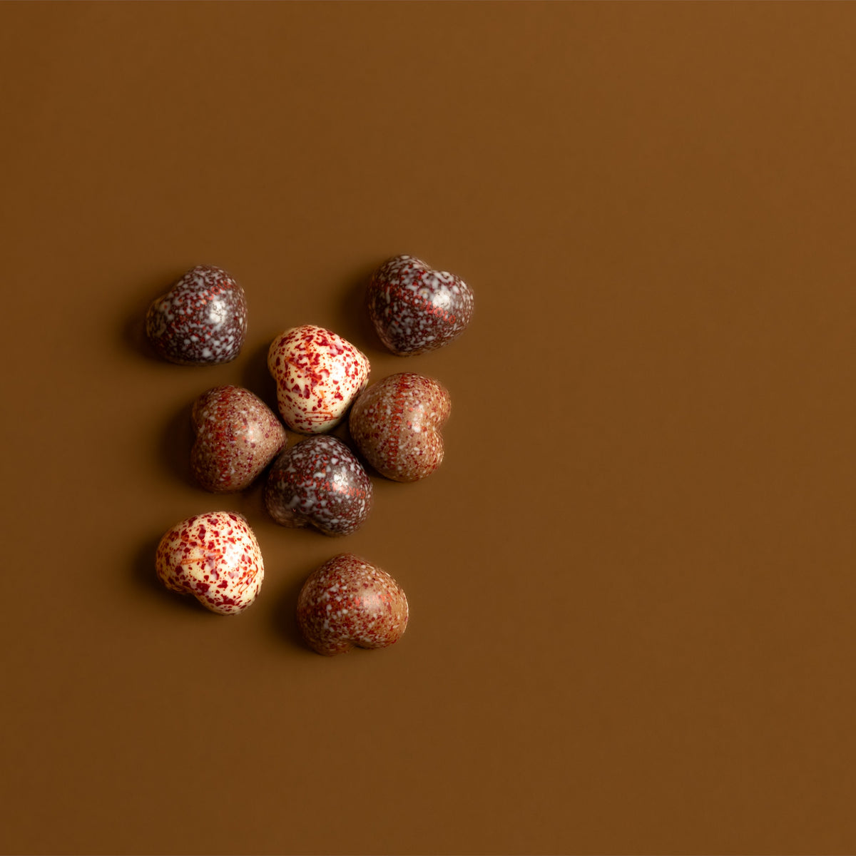Cuoricini di cioccolato decorati su sfondo chiaro